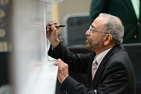 Dr. Patil signing the beam